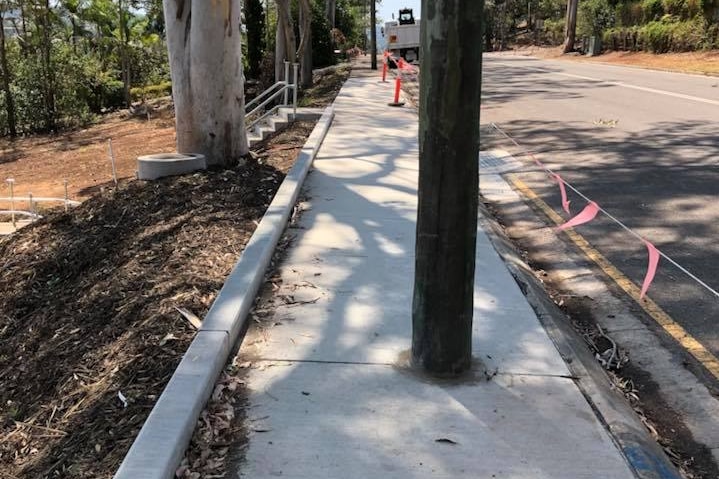 A pole in the middle of a footpath.