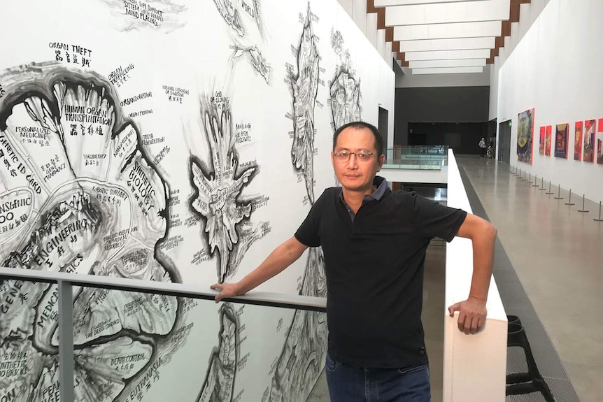 Qiu Zhijie with his Map of Technology Ethics at Brisbane's Gallery of Modern Art