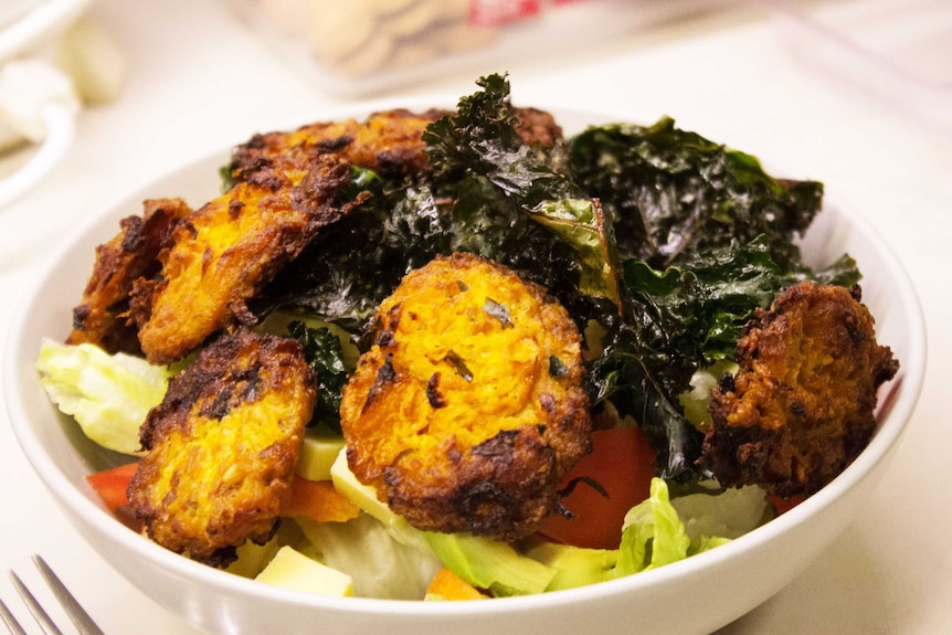 Pumpkin patties with salad and roast kale representing simple hacks to make meal preparation less time consuming and easier.