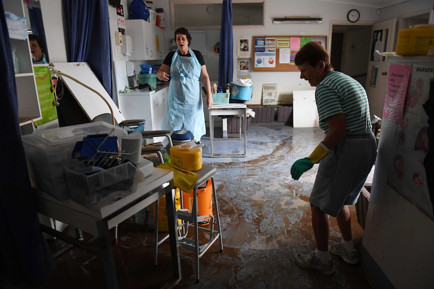 The Lismore Clinic staff clean up the treatment rooms after the levee broke.