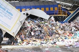 A truck dumps cardboard for recycling at Re Group's Hume facility