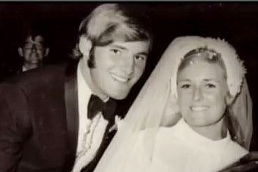 a man and woman dressed in a bridal gown on their wedding day