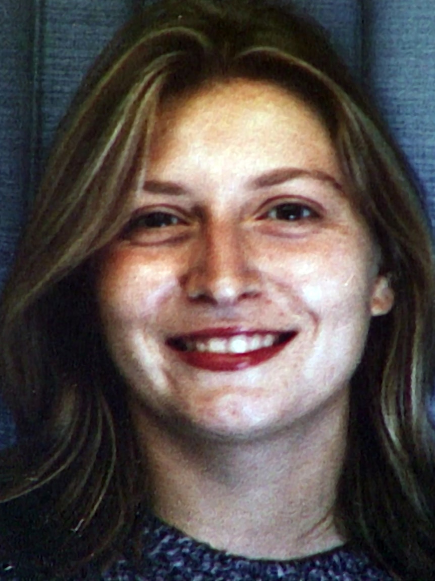 A young woman smiles at the camera.