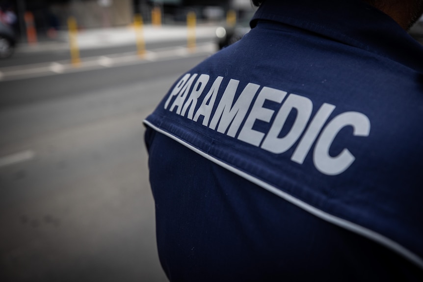 White writing on a blue shirt spells out the word paramedic.