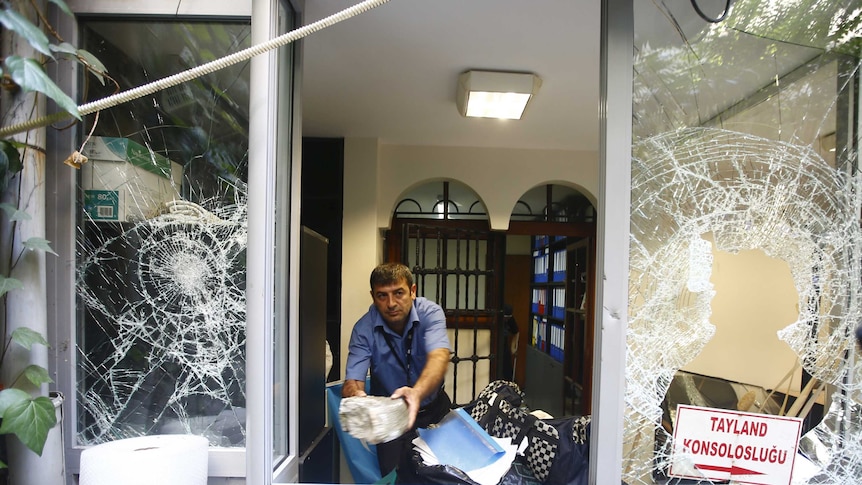 A man removes stones at the Thai honorary consulate in Istanbul, Turkey