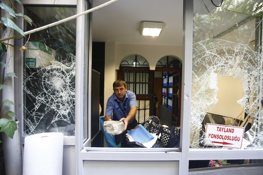 A man removes stones at the Thai honorary consulate in Istanbul, Turkey