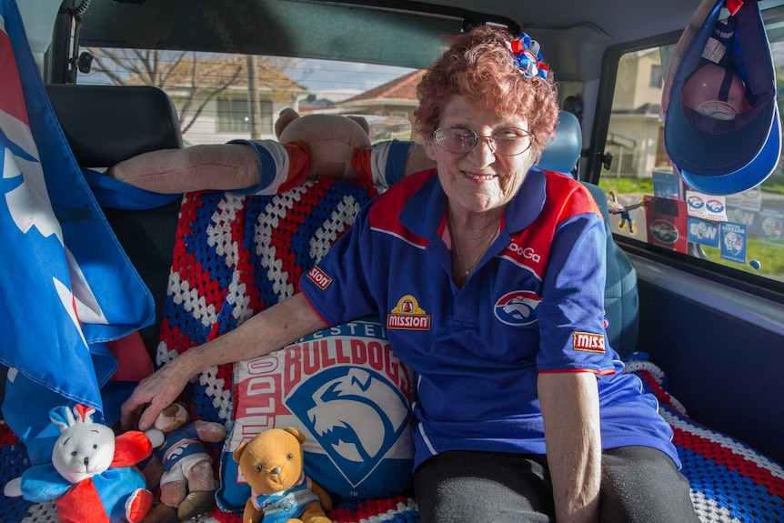 A die hard fan sits in her "dogsmobile" decorated with western bulldogs merchandise
