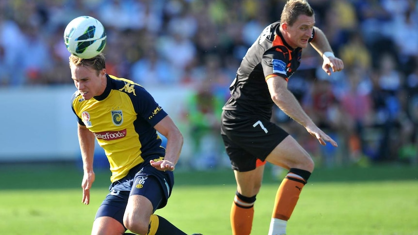 The Central Coast Mariners' Zachary Anderson (left) competes for the ball with Besart Berisha.