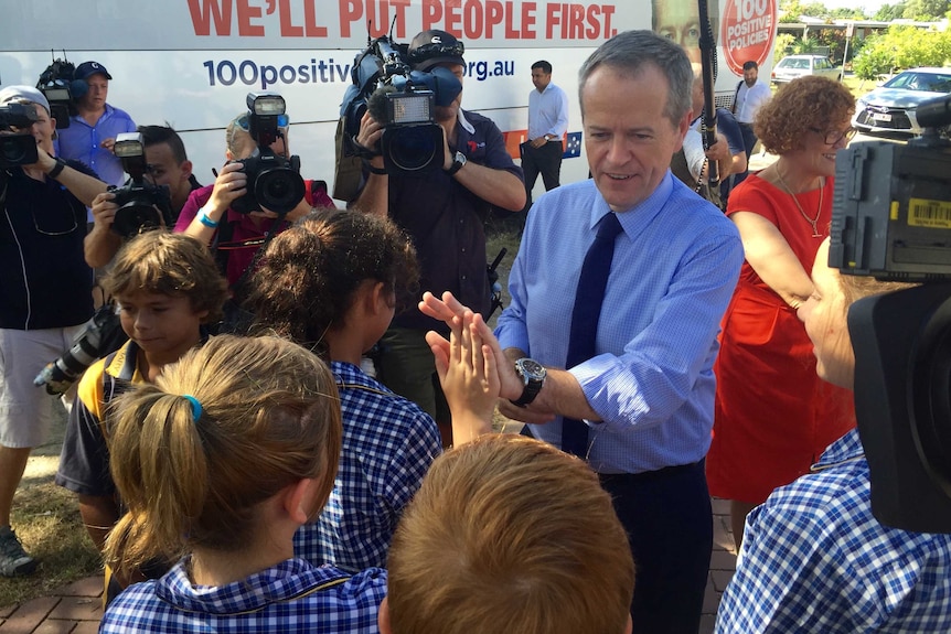 Bill Shorten high fives children in Townsville