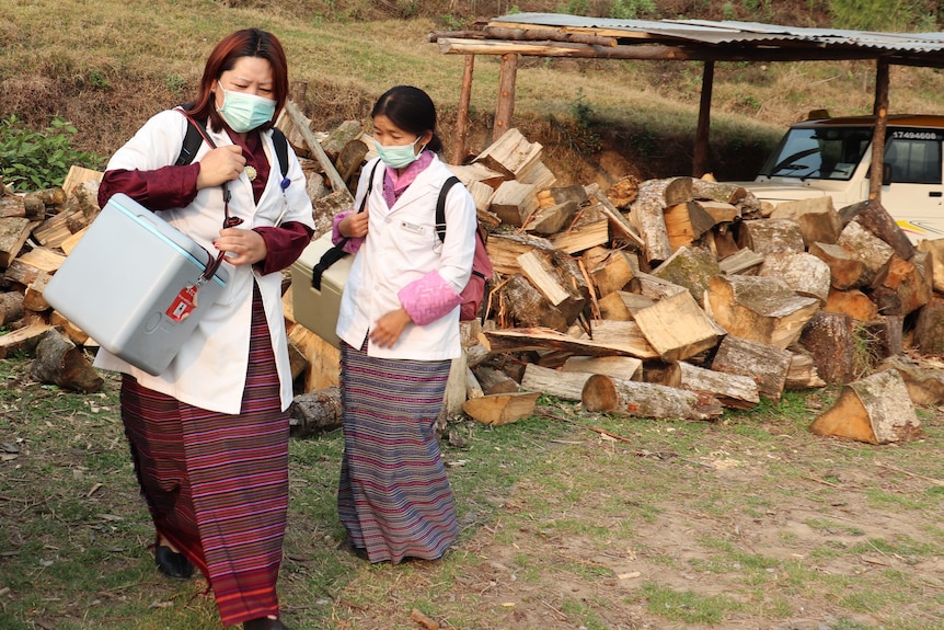 Two Bhutanese women wearing face masks 