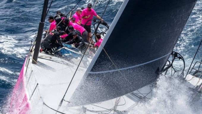 Yacht smashing through a wave.