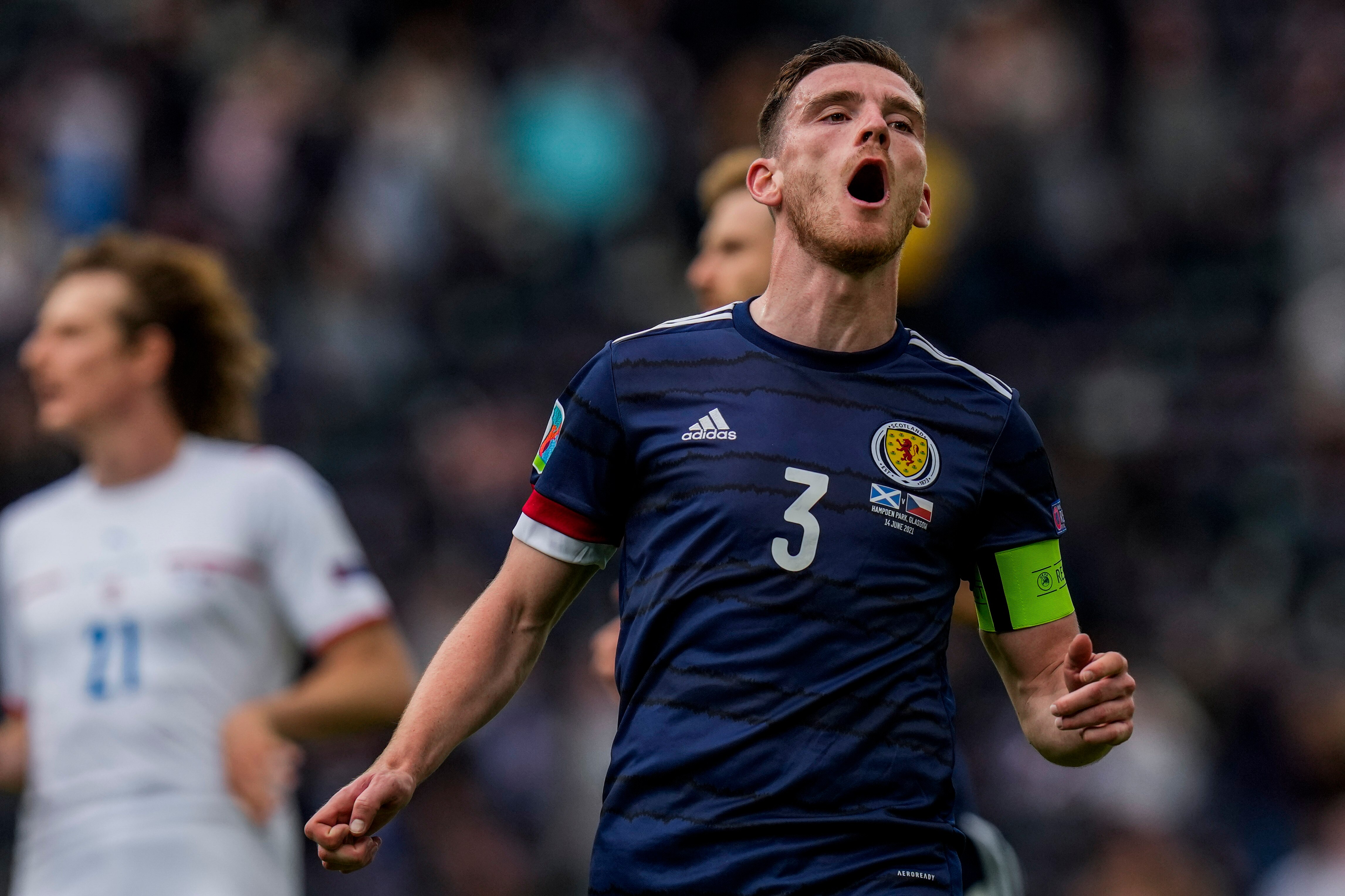 Andy Robertson has his mouth open and looks slightly up