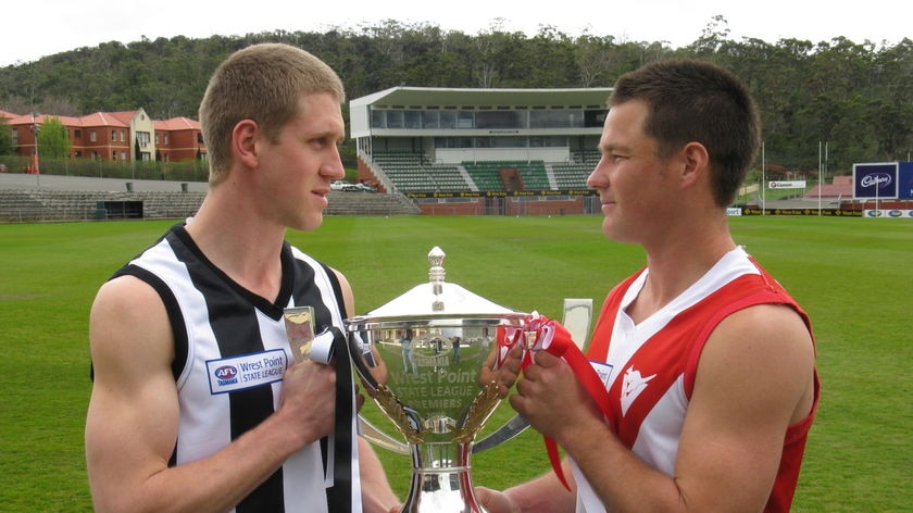 Arch rivals: Glenorchy's Shane Piuselli and Clarence's Nick Paine face off with the silverware.