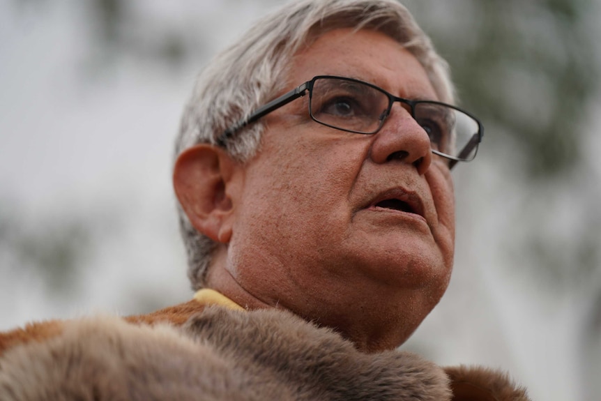 A close-up head shot of Ken Wyatt wearing glasses.