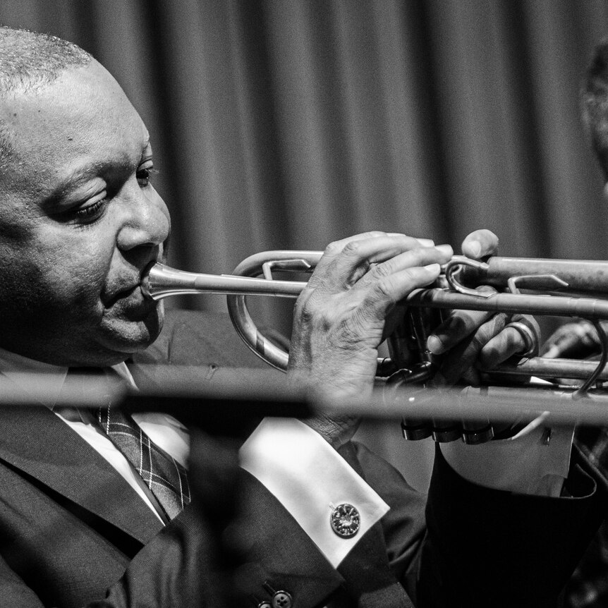 A monochrome shot of Wynton Marsalis in the trumpet section