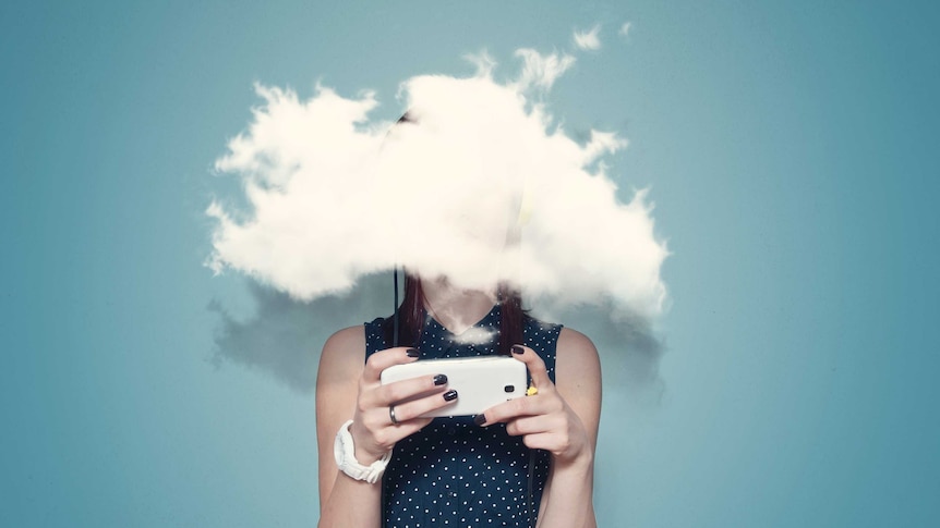 Young woman using phone with head in the clouds.