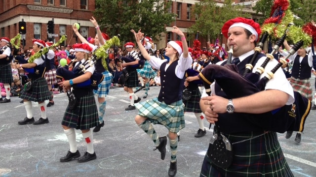 Bagpipers and highland dancers entertaining crowds