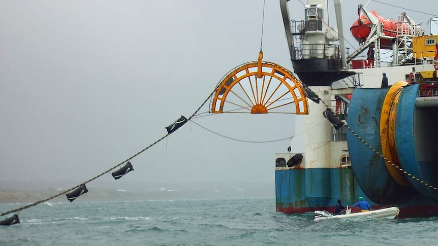 Basslink cable being laid in 2018, lining out from a reel attached to a ship