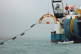 Basslink cable being laid in 2018, lining out from a reel atached to a ship