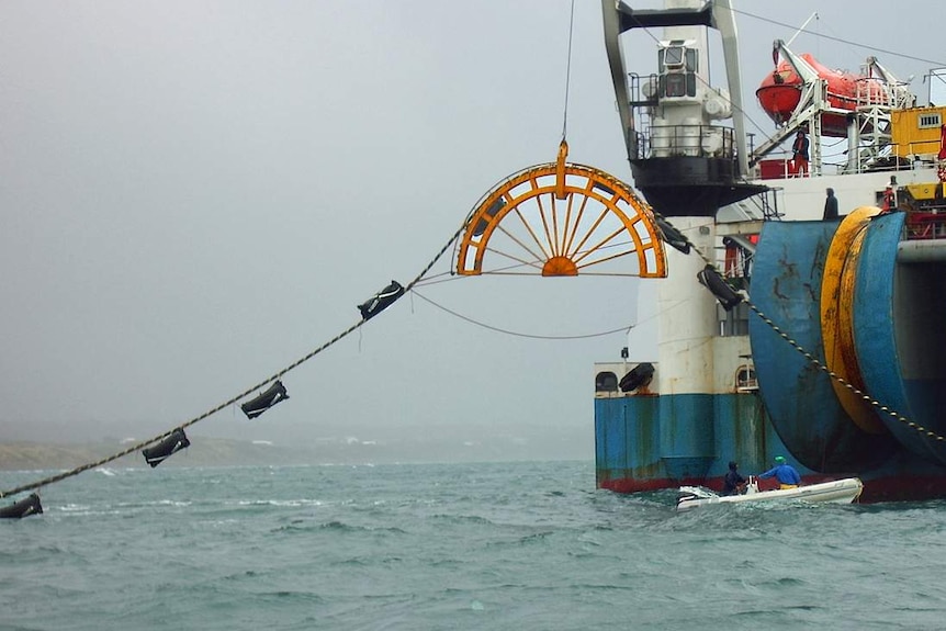 Basslink cable being laid in 2018, lining out from a reel attached to a ship