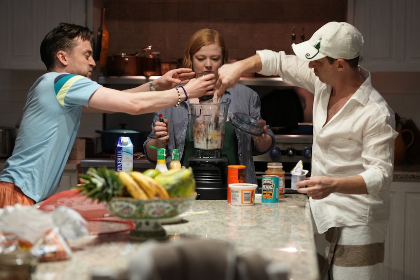 The three siblings pour different foods into a blender.