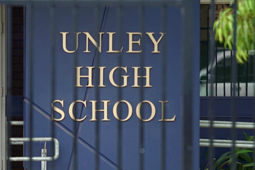 A student sits in front of the Unley High School.
