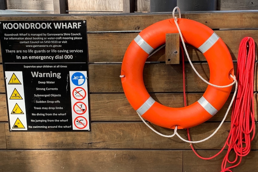 A warning sign and flotation device located at the Koondrook wharf.