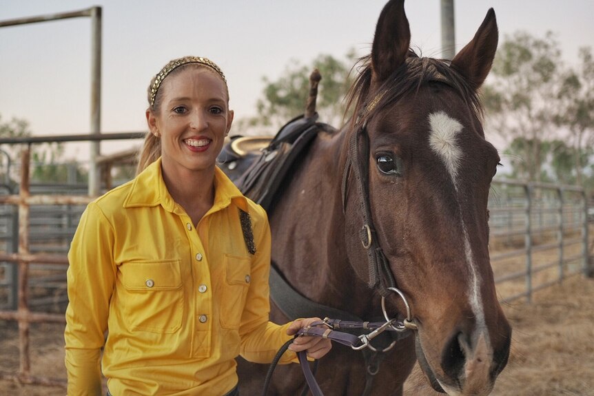 A portrait of Northern Territory trick rider Kirby McQueen with her horse.