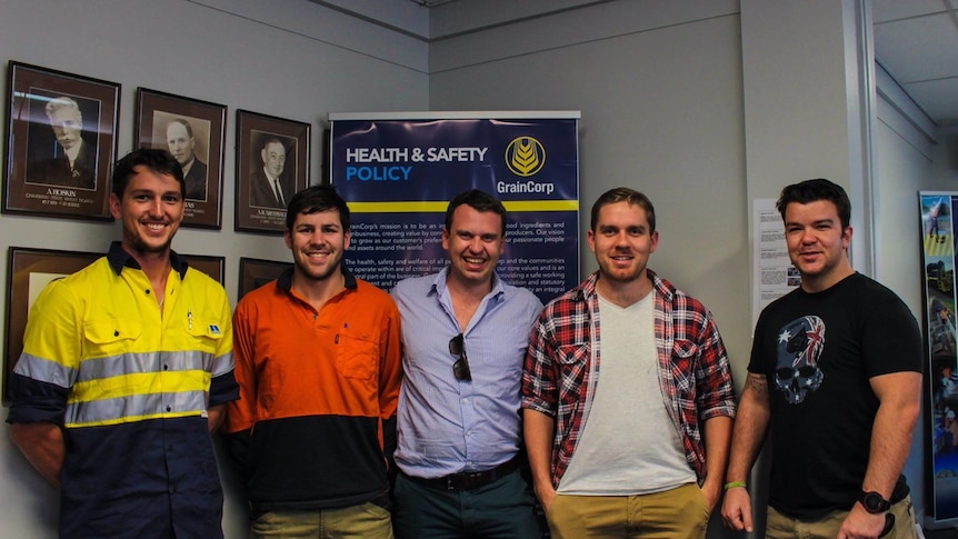 Casey and Luke Brown stand next to each other, gumtree in background