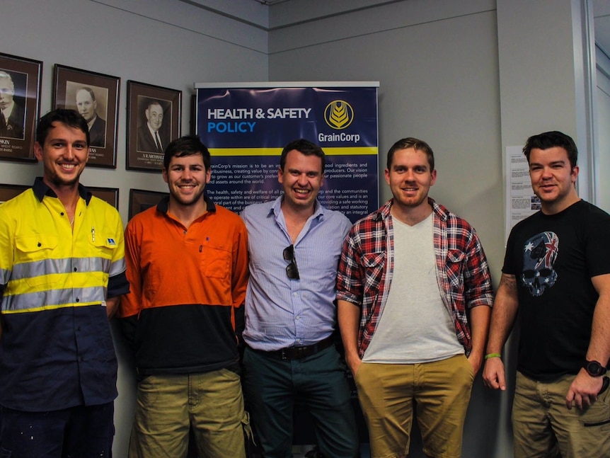 Casey and Luke Brown stand next to each other, gumtree in background