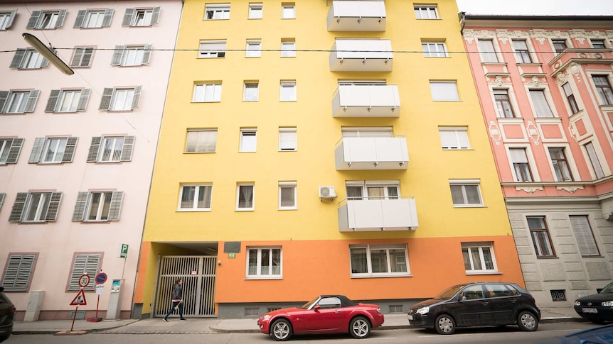 A brightly-coloured apartment building.