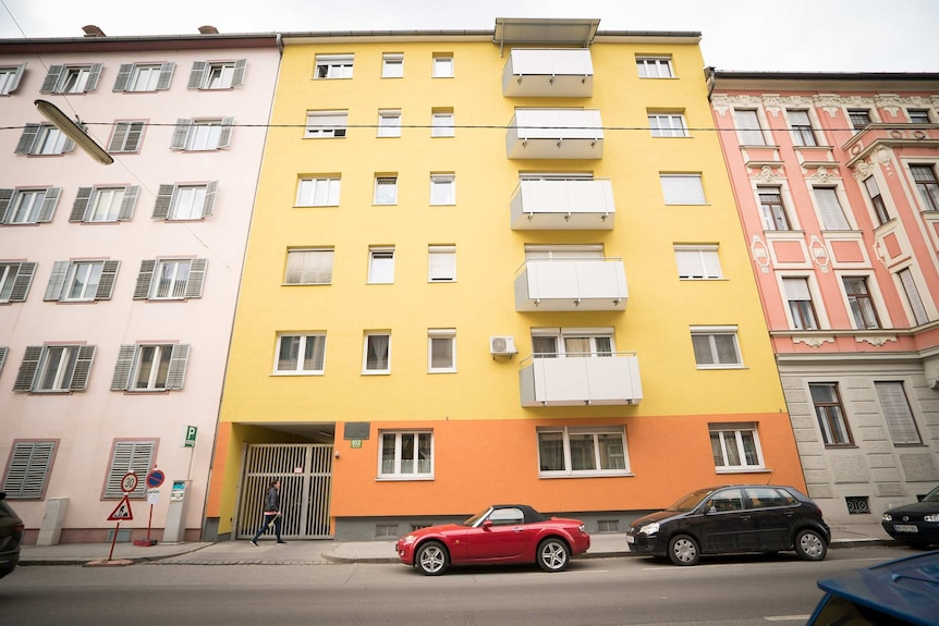 A brightly-coloured apartment building.