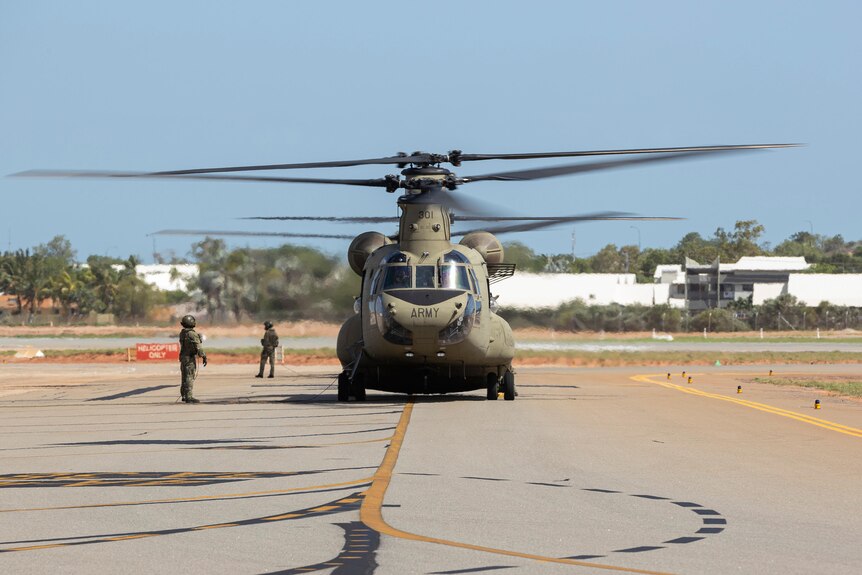 A front on picture of a large army helicopter on the tarmac