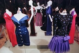 a group of dresses on mannequin on display 
