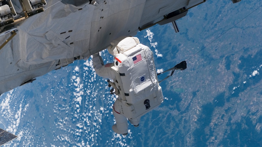 An astronaut in space above Earth