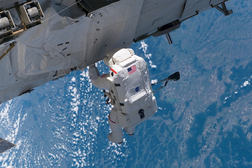 An astronaut in space above Earth