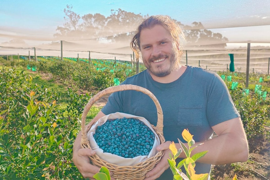 Rob holding blueberries 