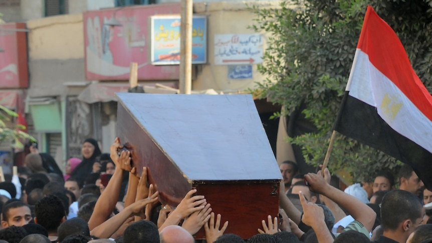Mourners in Cairo carry the coffin of Egyptian policeman Taha Ahmed Ibrahim, who was killed as Israeli troops pursued militants.