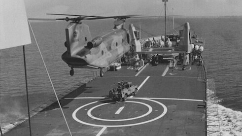 A RAAF Chinook C-47A preparing to lift an Army Land Rover from Tobruk's forward flight deck.