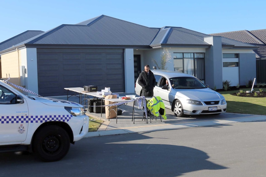 Police cars and officers outside the Yanchep house.