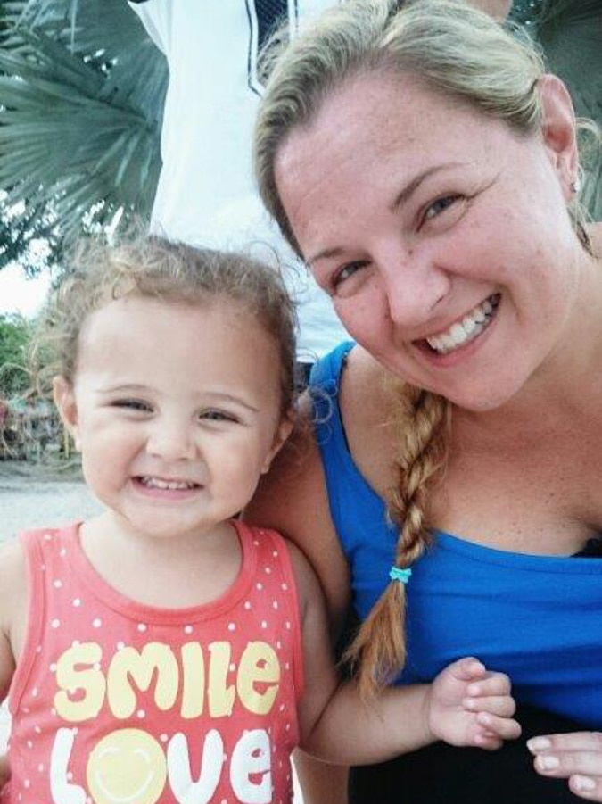 Mum and young daughter smiling.