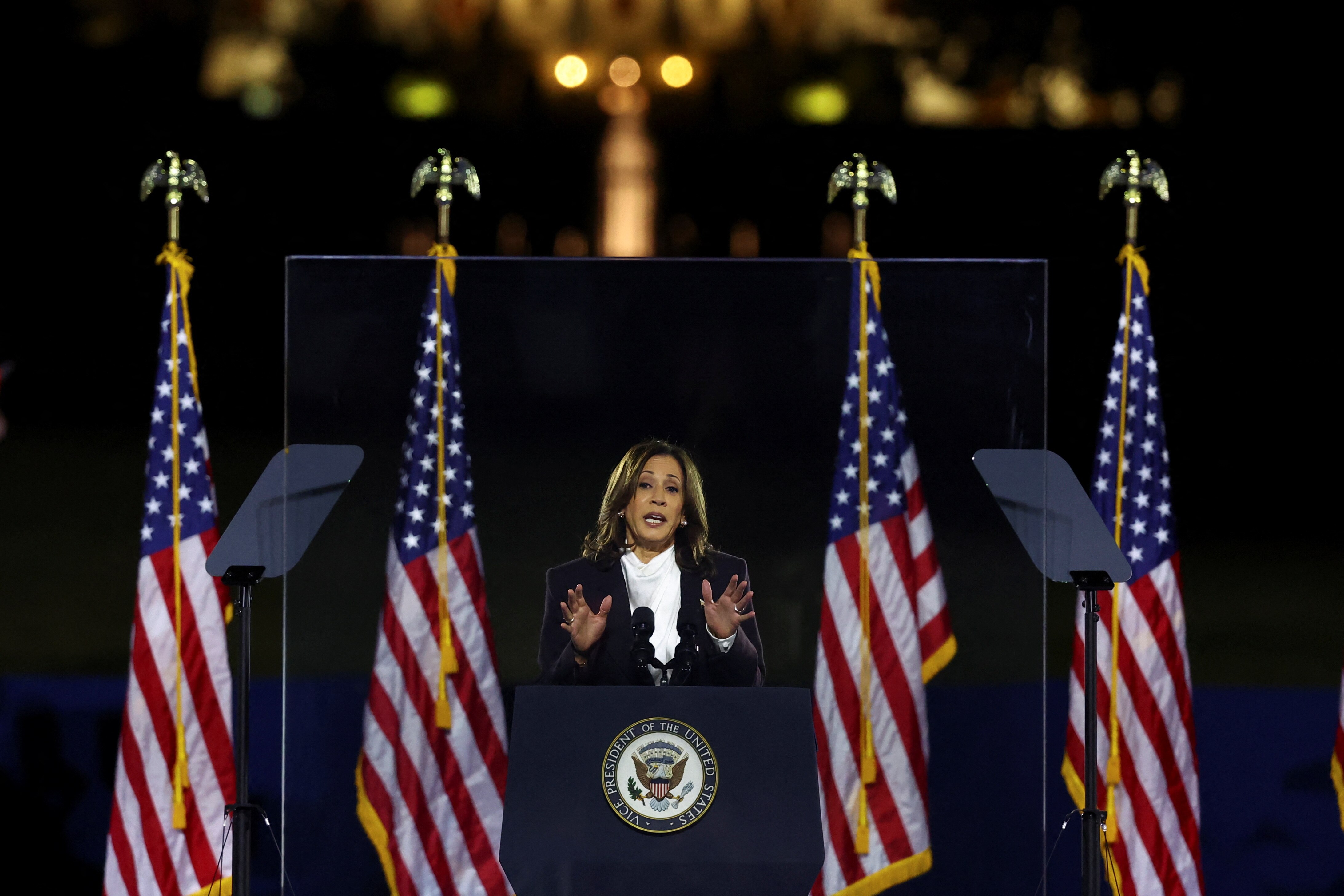 Flanked by US flags and a backdrop of the White House, Harris speaks at a rally