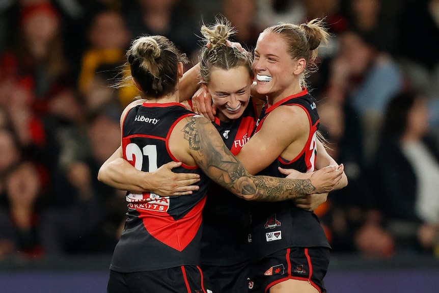 Jessica Wuetschner, Sophie Alexander and Stephanie Cain hug and smile