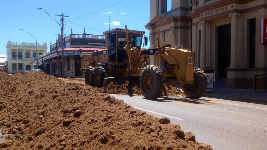 Dirt is dumped on Charters Towers street for filming of Breaker Morant documentary