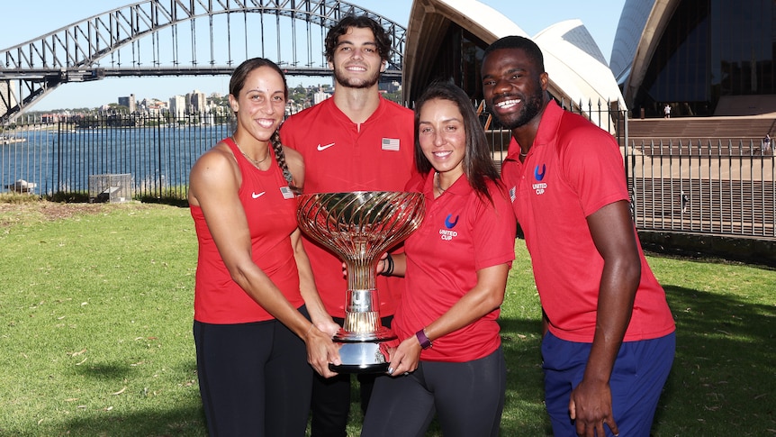 Four American professional tennis players hold the United Cup in Sydney.