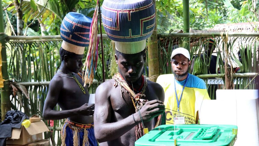 Boys and young men wearing special hats vote in Bougainville's historic referendum.