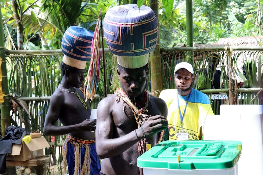 Boys and young men wearing special hats vote in Bougainville's historic referendum.