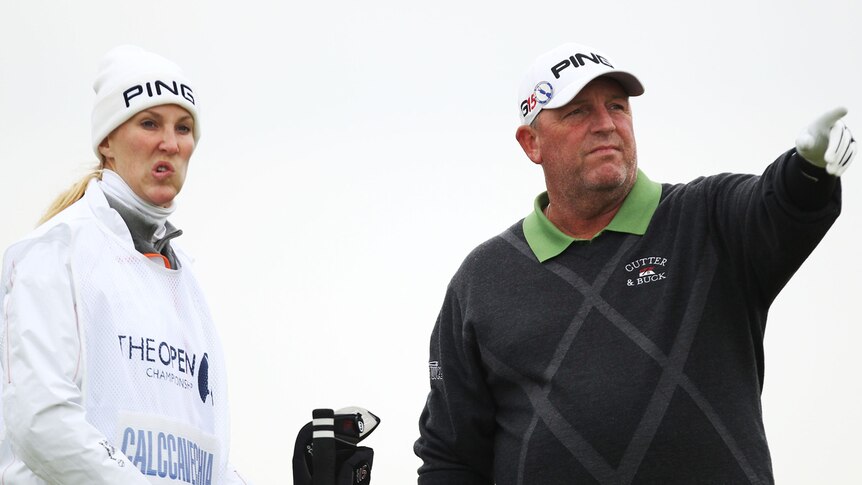 Mark Calcavecchia lines up a shot with his caddie and wife Brenda in the first round of the British Open.