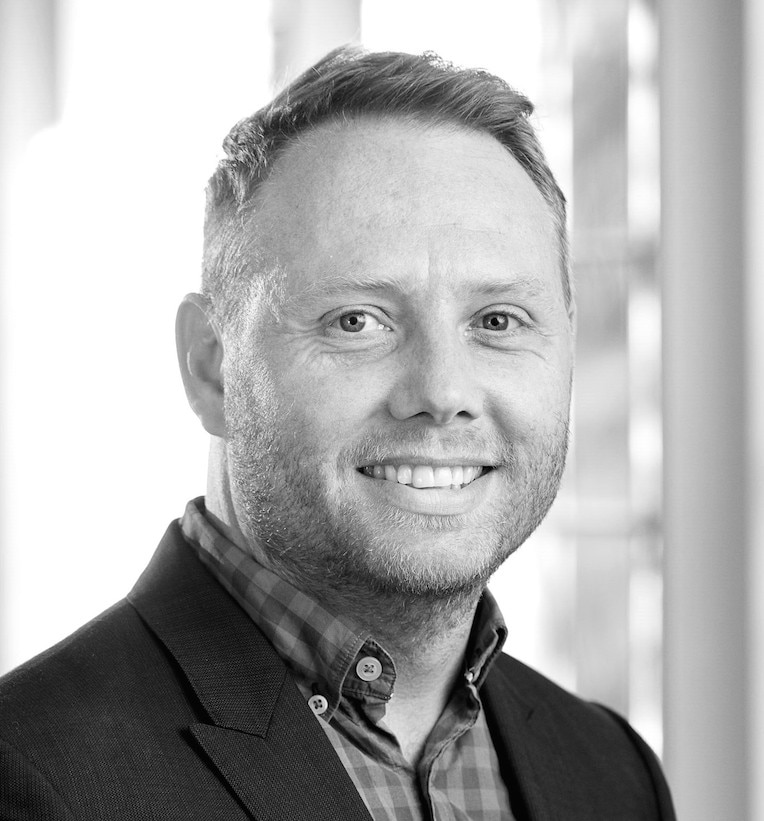 An adult caucasian male smiling.