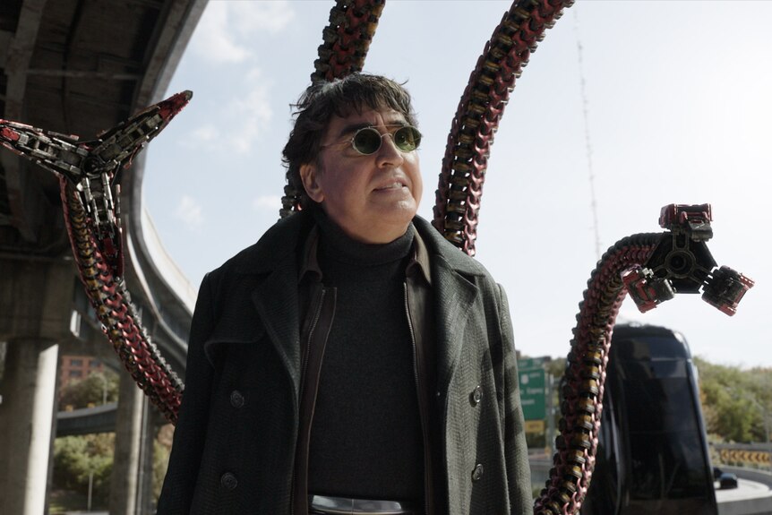 Doctor Octopus, a supervillain with black round sunglasses and robotic tentacles protruding from his back, grits his teeth